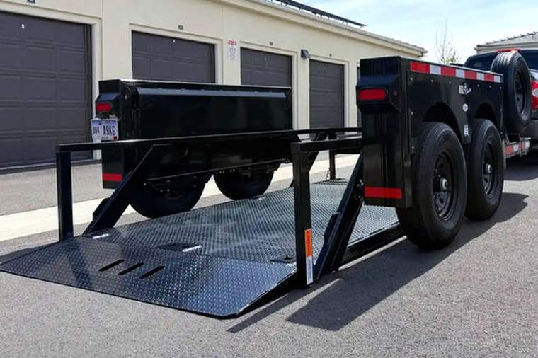 Tandem axle hydraulic drop deck trailer with the deck lowered flat to the pavement